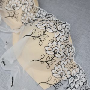 White lace with flowers and black embroidery