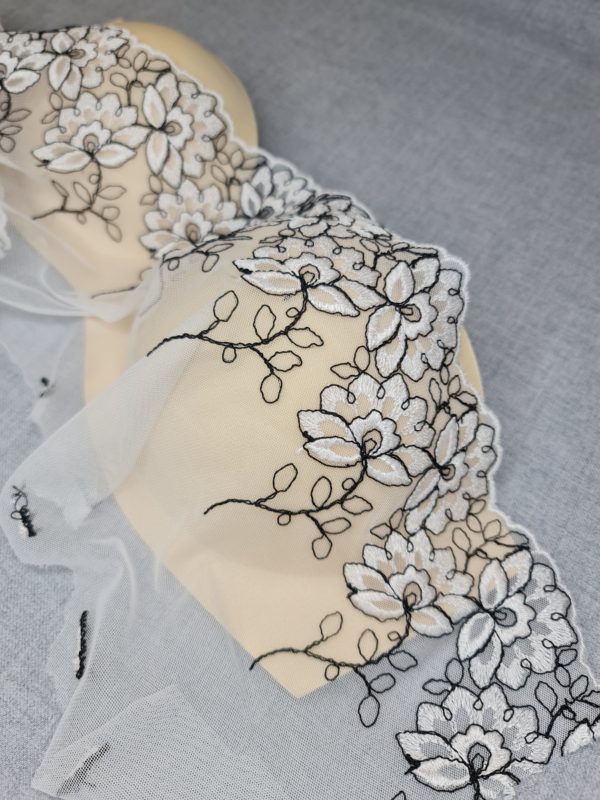 White lace with flowers and black embroidery